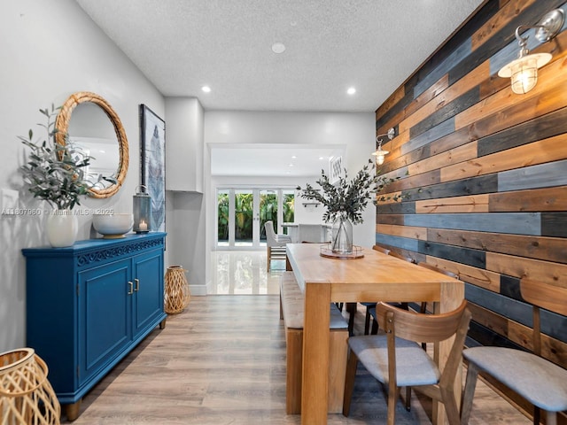 5930 SW 13th Ter, West Miami, FL 33144 - dining space with a textured ceiling, wooden walls, light wood-style floors, and recessed lighting