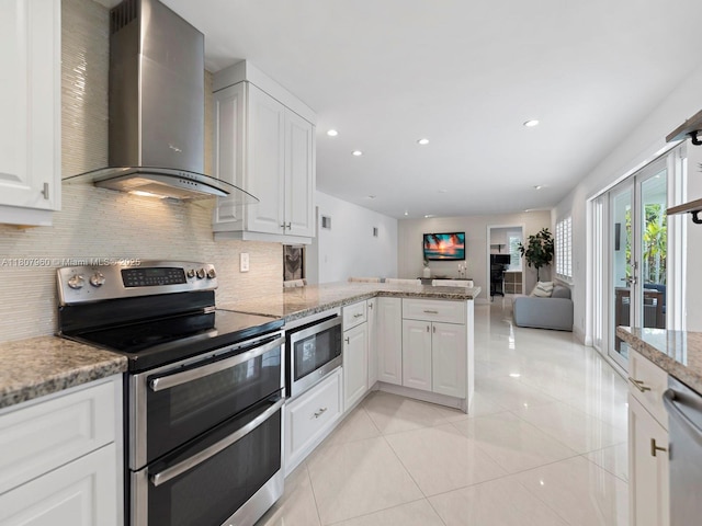 5930 SW 13th Ter, West Miami, FL 33144 - kitchen featuring wall chimney exhaust hood, stainless steel appliances, light tile patterned floors, backsplash, and a peninsula