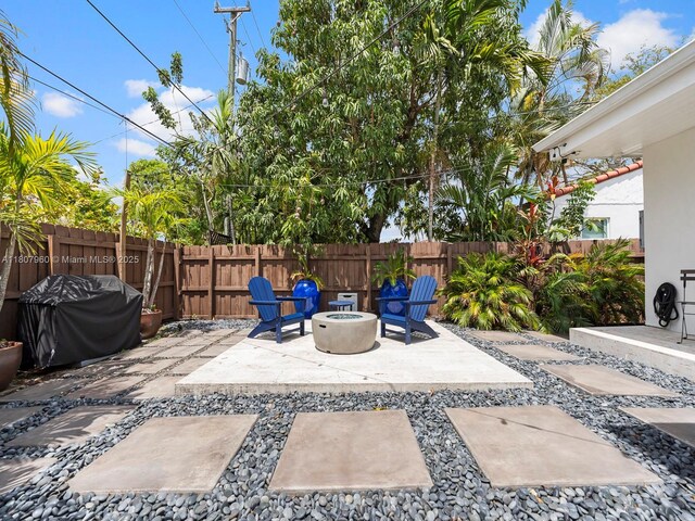 5930 SW 13th Ter, West Miami, FL 33144 - fenced backyard featuring an outdoor fire pit, a patio area, and a grill