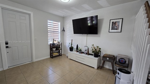 10846 SW 240th Ln, Homestead, FL 33032 - living room featuring light tile patterned floors and baseboards
