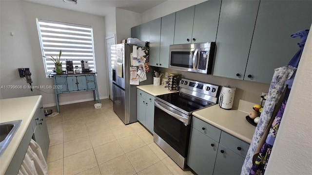 10846 SW 240th Ln, Homestead, FL 33032 - kitchen with stainless steel appliances, light countertops, light tile patterned floors, and gray cabinetry