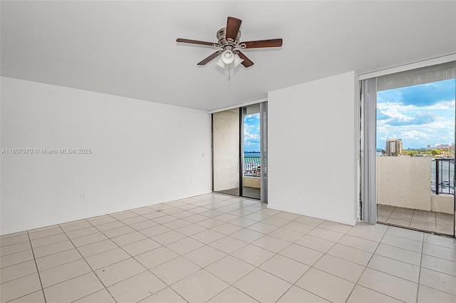 555 NE 15th St Unit 603, Miami, FL 33132 - empty room featuring ceiling fan, expansive windows, and light tile patterned floors