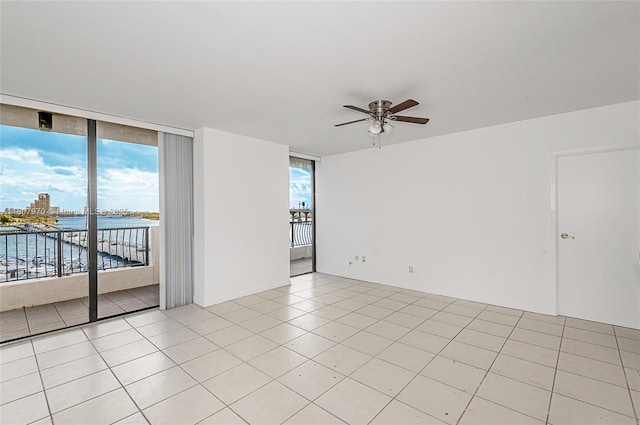 555 NE 15th St Unit 603, Miami, FL 33132 - empty room with a ceiling fan, plenty of natural light, a water view, and light tile patterned flooring