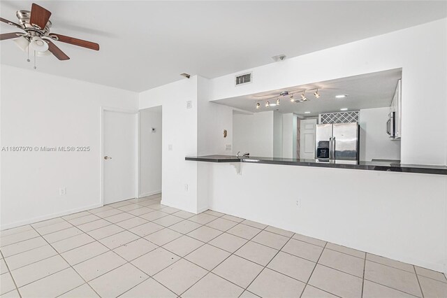 555 NE 15th St Unit 603, Miami, FL 33132 - kitchen featuring appliances with stainless steel finishes, dark countertops, a ceiling fan, and a peninsula