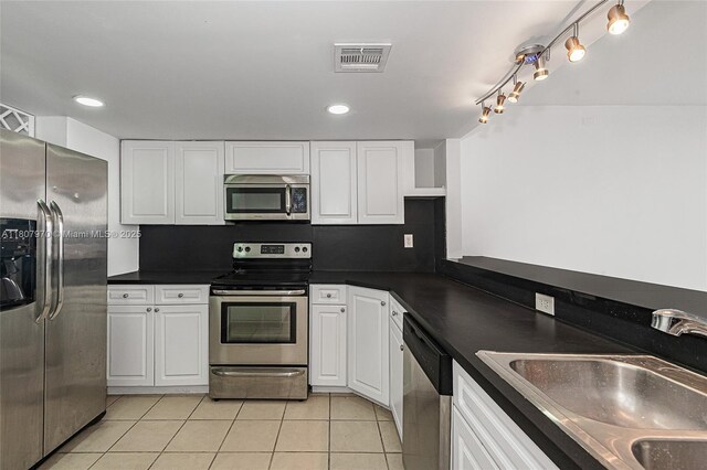 555 NE 15th St Unit 603, Miami, FL 33132 - kitchen featuring stainless steel appliances, a sink, light tile patterned floors, white cabinetry, and recessed lighting