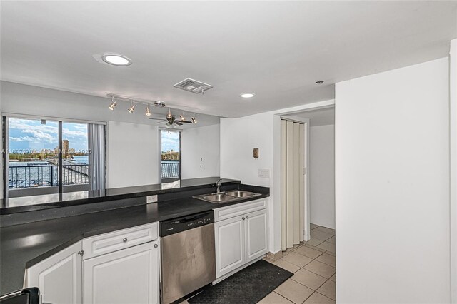 555 NE 15th St Unit 603, Miami, FL 33132 - kitchen featuring dishwasher, a sink, dark countertops, light tile patterned floors, and white cabinetry