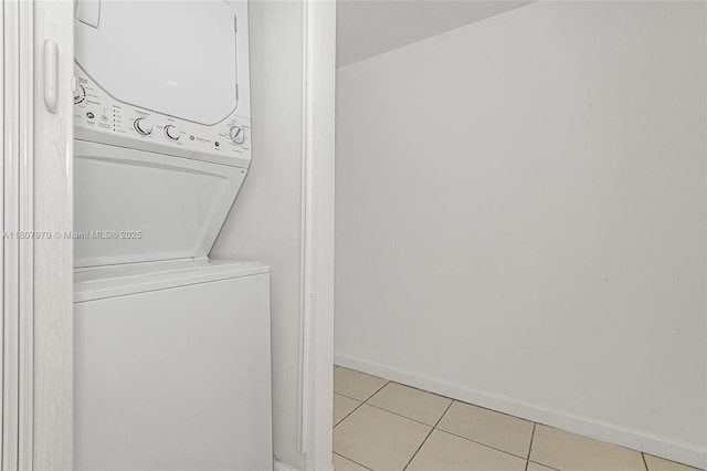 555 NE 15th St Unit 603, Miami, FL 33132 - laundry room featuring stacked washer / dryer, light tile patterned floors, and baseboards