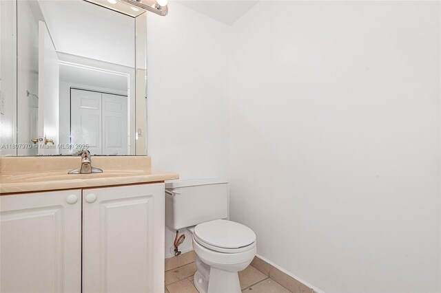 555 NE 15th St Unit 603, Miami, FL 33132 - half bathroom with toilet, tile patterned flooring, vanity, and baseboards