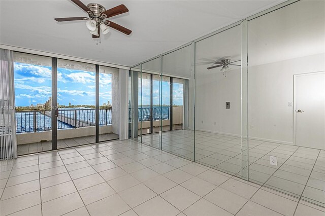 555 NE 15th St Unit 603, Miami, FL 33132 - empty room with a ceiling fan, light tile patterned flooring, and floor to ceiling windows