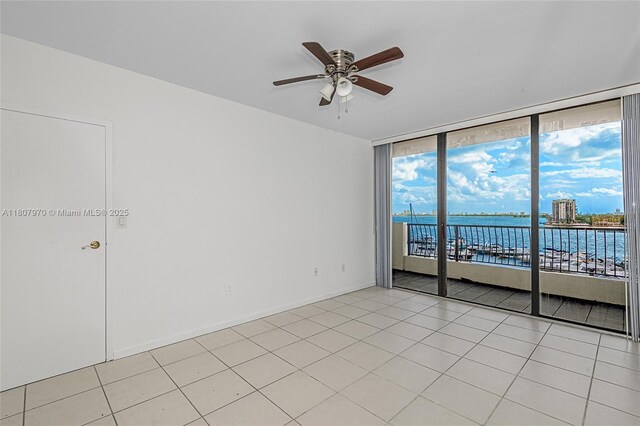 555 NE 15th St Unit 603, Miami, FL 33132 - unfurnished room featuring a ceiling fan, a water view, expansive windows, and light tile patterned floors