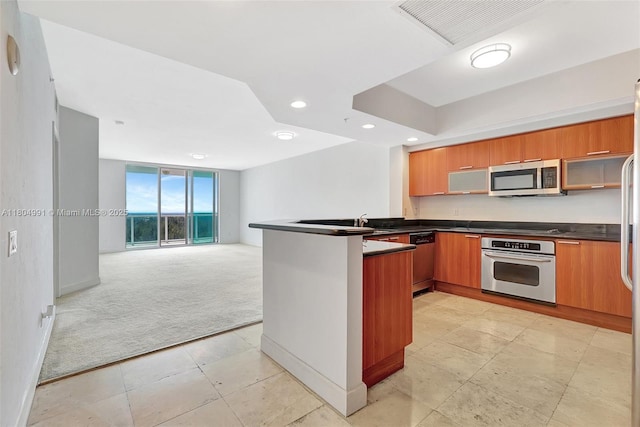 14951 Royal Oaks Ln Unit 1406, North Miami, FL 33181 - kitchen with appliances with stainless steel finishes, light carpet, dark countertops, open floor plan, and recessed lighting