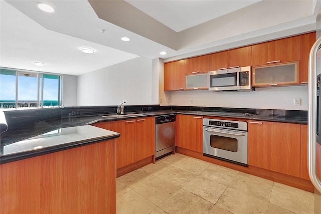 14951 Royal Oaks Ln Unit 1406, North Miami, FL 33181 - kitchen with appliances with stainless steel finishes, a sink, modern cabinets, recessed lighting, and brown cabinets