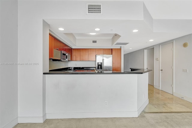 14951 Royal Oaks Ln Unit 1406, North Miami, FL 33181 - kitchen featuring appliances with stainless steel finishes, dark countertops, a peninsula, recessed lighting, and light colored carpet