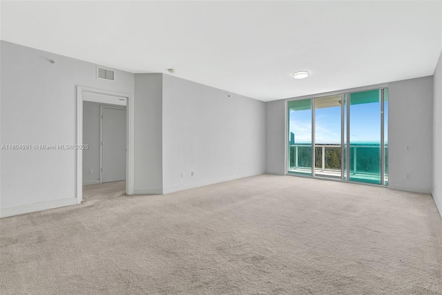 14951 Royal Oaks Ln Unit 1406, North Miami, FL 33181 - unfurnished room with light carpet, expansive windows, and baseboards