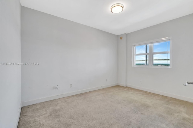 14951 Royal Oaks Ln Unit 1406, North Miami, FL 33181 - empty room featuring light carpet and baseboards
