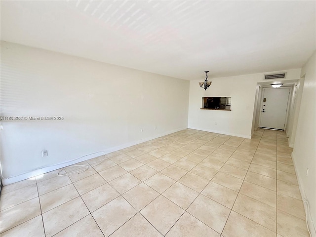 10825 SW 112th Ave Unit 302, Miami, FL 33176 - empty room with light tile patterned flooring, a chandelier, and baseboards