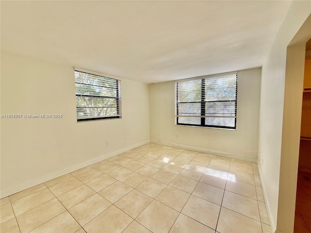 10825 SW 112th Ave Unit 302, Miami, FL 33176 - spare room with light tile patterned floors and baseboards