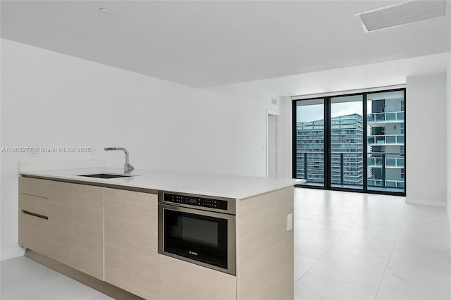 1300 S Miami Ave Unit 3211, Miami, FL 33130 - kitchen featuring stainless steel oven, a sink, modern cabinets, light countertops, and baseboards