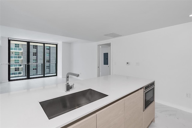 1300 S Miami Ave Unit 3211, Miami, FL 33130 - kitchen with a sink, light marble finish flooring, light countertops, modern cabinets, and baseboards