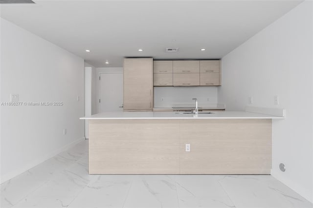 1300 S Miami Ave Unit 3211, Miami, FL 33130 - kitchen with a sink, light countertops, a peninsula, recessed lighting, and light marble finish flooring