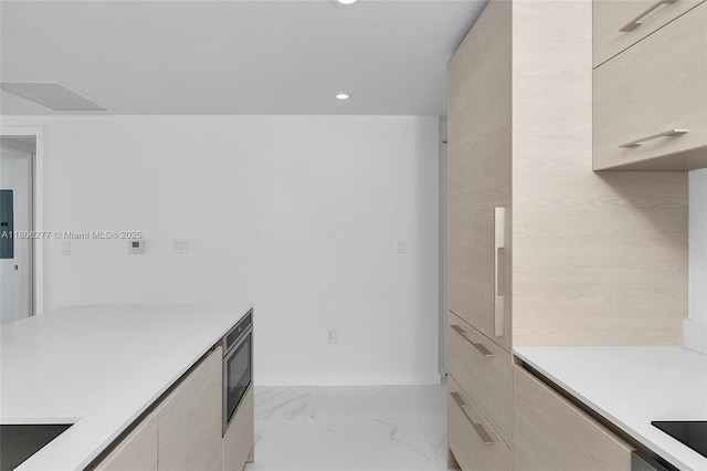 1300 S Miami Ave Unit 3211, Miami, FL 33130 - kitchen featuring modern cabinets, light countertops, recessed lighting, light marble finish floors, and baseboards