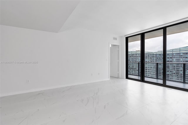 1300 S Miami Ave Unit 3211, Miami, FL 33130 - unfurnished room with expansive windows, baseboards, and light marble finish flooring