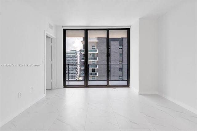 1300 S Miami Ave Unit 3211, Miami, FL 33130 - spare room with a wall of windows, marble finish flooring, and baseboards