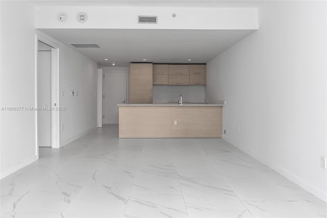 1300 S Miami Ave Unit 3211, Miami, FL 33130 - kitchen with modern cabinets, light marble finish flooring, baseboards, and a peninsula