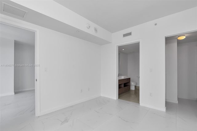 1300 S Miami Ave Unit 3211, Miami, FL 33130 - unfurnished bedroom with light marble finish floors, baseboards, and ensuite bathroom
