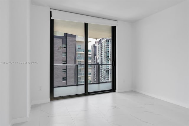 1300 S Miami Ave Unit 3211, Miami, FL 33130 - unfurnished room featuring marble finish flooring, healthy amount of natural light, baseboards, a city view, and a wall of windows