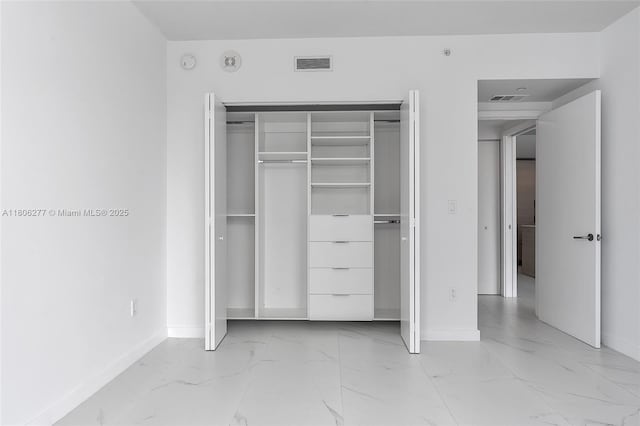 1300 S Miami Ave Unit 3211, Miami, FL 33130 - unfurnished bedroom featuring light marble finish flooring, baseboards, and a closet