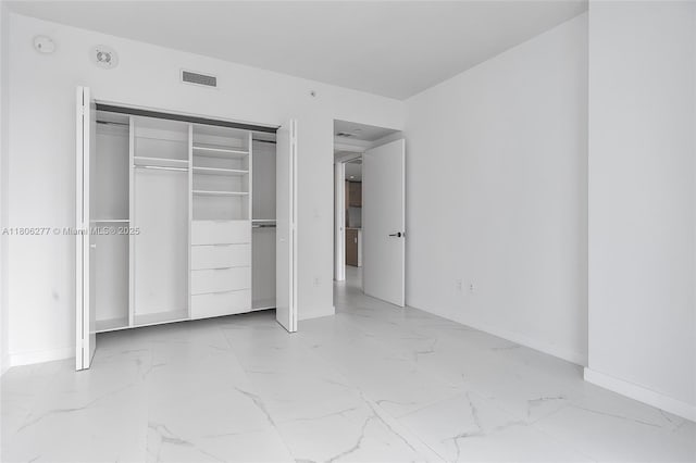 1300 S Miami Ave Unit 3211, Miami, FL 33130 - unfurnished bedroom with light marble finish flooring, baseboards, and a closet