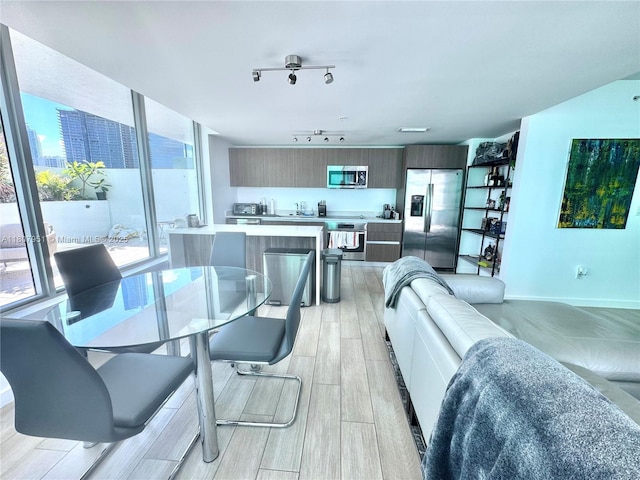 1600 SW 1st Ave Unit 910, Miami, FL 33129 - living room featuring light wood finished floors and rail lighting