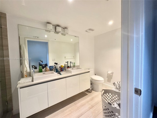 1600 SW 1st Ave Unit 910, Miami, FL 33129 - bathroom featuring double vanity, toilet, and recessed lighting