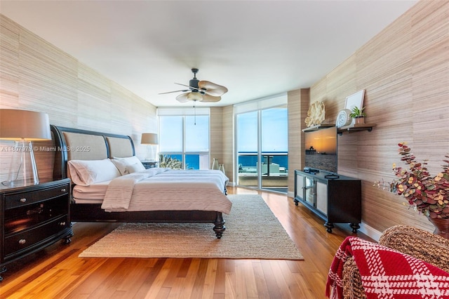 101 S Fort Lauderdale Beach Blvd Unit 1001, Fort Lauderdale, FL 33316 - bedroom featuring access to outside, wallpapered walls, wood finished floors, ceiling fan, and floor to ceiling windows