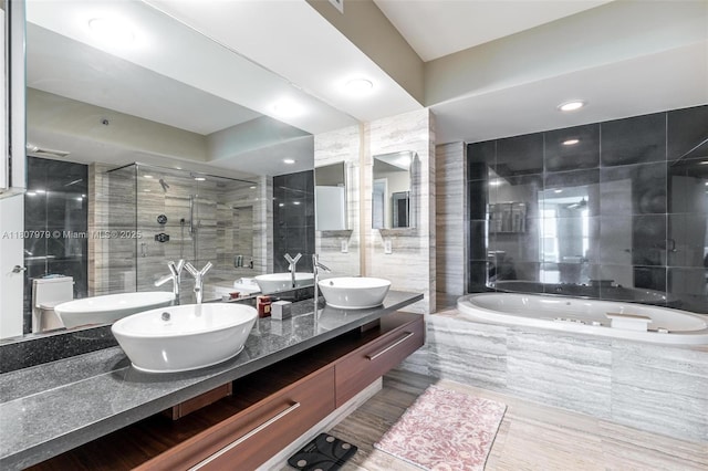 101 S Fort Lauderdale Beach Blvd Unit 1001, Fort Lauderdale, FL 33316 - bathroom with a garden tub, tile walls, double vanity, a stall shower, and recessed lighting