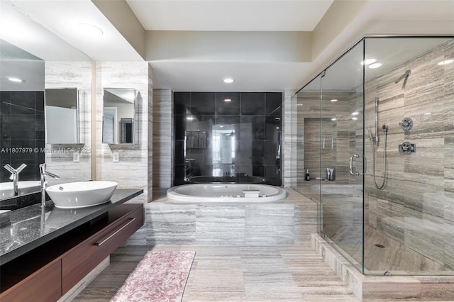101 S Fort Lauderdale Beach Blvd Unit 1001, Fort Lauderdale, FL 33316 - full bath featuring a garden tub, vanity, a stall shower, and tile walls