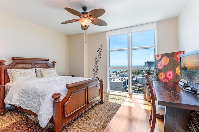 101 S Fort Lauderdale Beach Blvd Unit 1001, Fort Lauderdale, FL 33316 - bedroom featuring a wall of windows, light wood-style floors, and ceiling fan