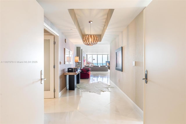 101 S Fort Lauderdale Beach Blvd Unit 1001, Fort Lauderdale, FL 33316 - hallway with a chandelier, tile patterned floors, and baseboards