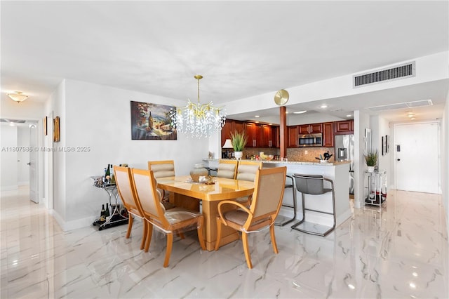 3140 S Ocean Dr Unit 2310, Hallandale Beach, FL 33009 - dining room with light marble finish flooring, a chandelier, and baseboards