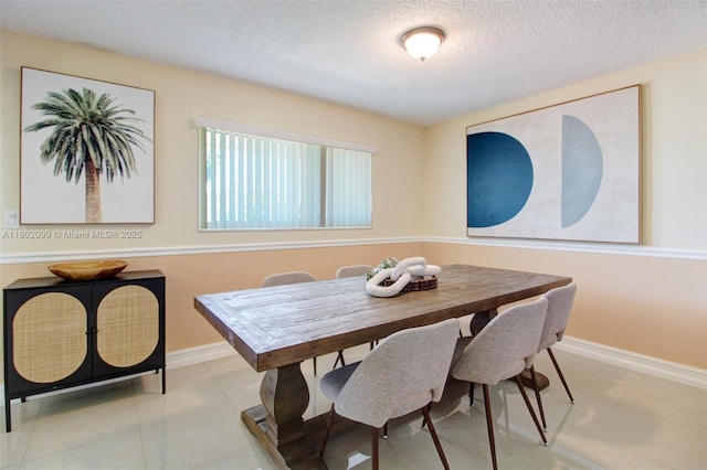 7891 SW 9th Ter, Miami, FL 33144 - dining area with a textured ceiling and baseboards