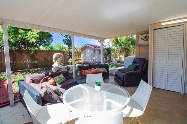 7891 SW 9th Ter, Miami, FL 33144 - fenced backyard featuring a patio, outdoor dining area, and outdoor lounge area