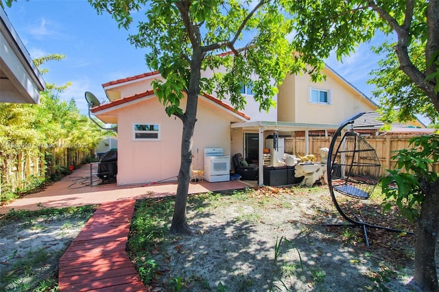 7891 SW 9th Ter, Miami, FL 33144 - back of house featuring a patio area, a fenced backyard, an outdoor hangout area, and stucco siding
