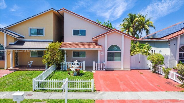 7891 SW 9th Ter, Miami, FL 33144 - view of front facade featuring a tile roof, a gate, stucco siding, and covered porch