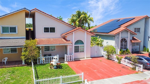 7891 SW 9th Ter, Miami, FL 33144 - rear view of property featuring a gate, a tile roof, stucco siding, covered porch, and a fenced front yard