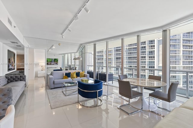 495 Brickell Ave Unit 2304, Miami, FL 33131 - living area featuring tile patterned floors, rail lighting, healthy amount of natural light, and floor to ceiling windows