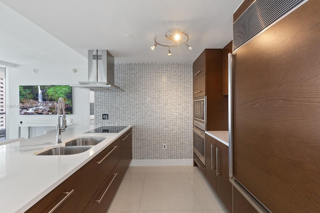 495 Brickell Ave Unit 2304, Miami, FL 33131 - kitchen with modern cabinets, wall chimney range hood, a sink, light countertops, and built in fridge