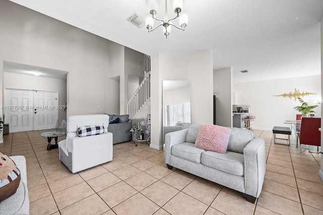 15490 SW 18th Ln, Miami, FL 33185 - living room featuring light tile patterned flooring, a chandelier, stairs, a high ceiling, and baseboards