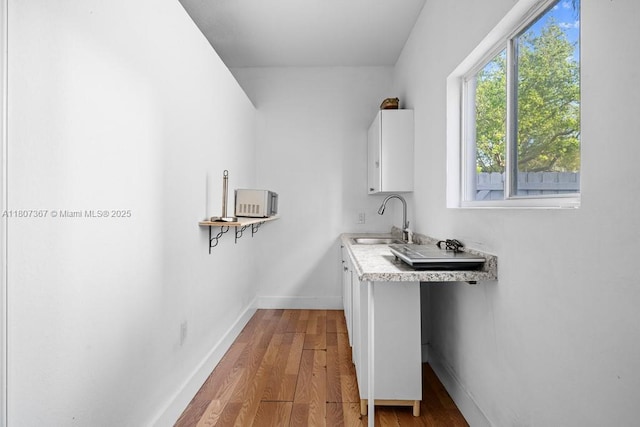 15490 SW 18th Ln, Miami, FL 33185 - laundry room featuring a sink, wood finished floors, and baseboards