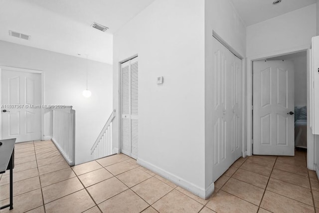 15490 SW 18th Ln, Miami, FL 33185 - corridor featuring light tile patterned floors, an upstairs landing, and baseboards